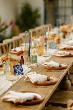 a long table with plates and napkins on it