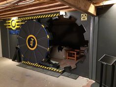 an empty garage with a large wheel on the floor and other equipment in it's storage area