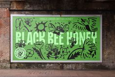 a large green poster on the side of a brick building that says black blvd