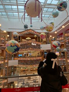 a person in a library taking pictures with their cell phone