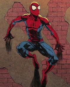 spider - man in front of a brick wall with his hands on the ground and arms outstretched