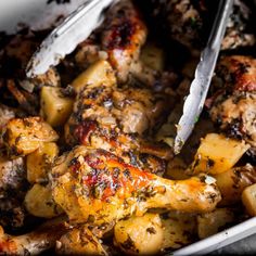 a close up of a plate of food with meat and potatoes on it, next to a knife