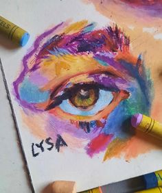 colored pencils and crayons are used to draw an image of the eye