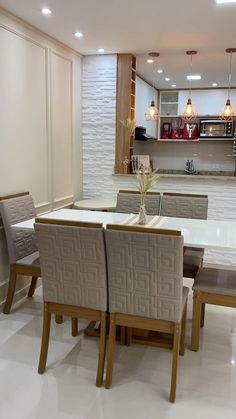 a dining room table and chairs with white tile flooring