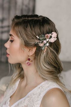 a woman with blonde hair and flowers in her hair is wearing a flowery headpiece