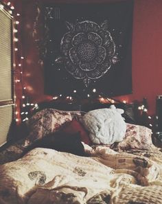 an instagram photo of someone's bed with lights on the headboard and blankets