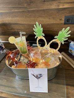 a metal bucket filled with lots of candy and decorations on top of a table next to a phone