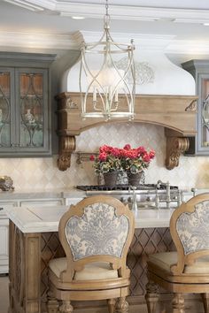 two chairs sitting in front of a kitchen island