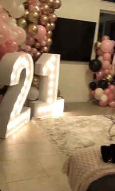 a room decorated with balloons and lights for the new year's eve celebration at home