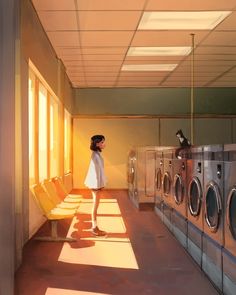 a woman standing in front of washing machines