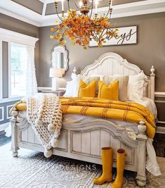 the bedroom is decorated in yellow and gray colors, with white bedding and pillows