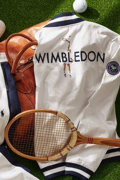 a white jacket with wimbledon on it next to a tennis racquet and ball