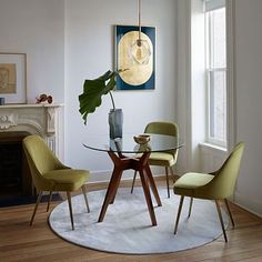 a dining room table with four chairs and a plant in the middle on top of it