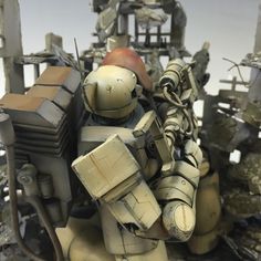 an action figure is posed in front of a pile of rubble and broken metal pieces