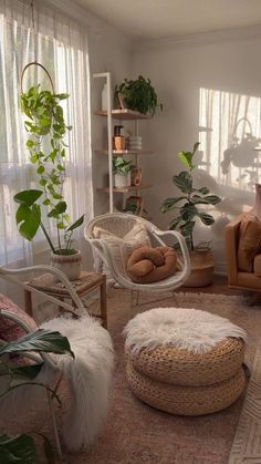 a living room filled with lots of furniture and plants