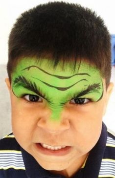 a young boy with his face painted green