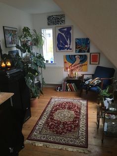 a living room filled with furniture and lots of pictures hanging on the wall above it