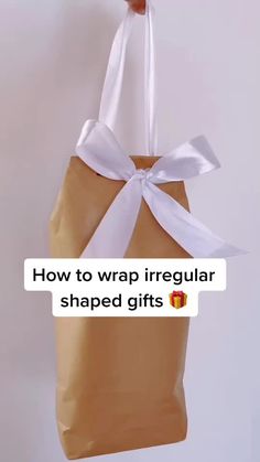 a brown bag with white ribbon hanging from it's side and the words how to wrap irregular shaped gifts