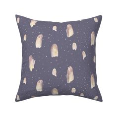 a pillow with penguins on it and stars in the sky behind them, both blue