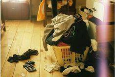 a pile of clothes sitting on top of a wooden floor