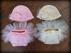 three crocheted hats with white and pink tulle, one in the shape of a baby's hat