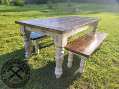 a wooden table and bench sitting in the grass