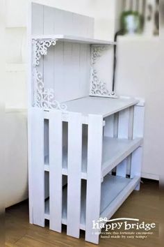 a white wooden shelf sitting on top of a hard wood floor