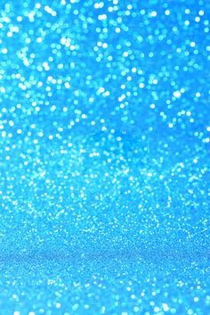 a blue glitter background with small white dots