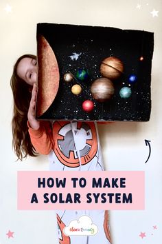A girl wearing a space onesie holds up a large cardboard model of the solar system. Make A Solar System, Solar System Projects For Kids, Solar System Model, Solar System Projects, Steam Projects, Eco Friendly Art, System Model
