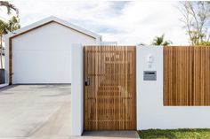 a white house with wooden doors and windows