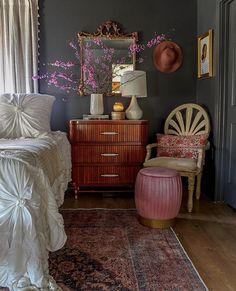 a bedroom with a bed, dresser and chair