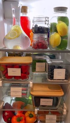 an open refrigerator filled with lots of different types of fruits and veggies in containers