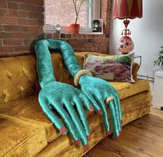a couch that has some kind of monster hand on it