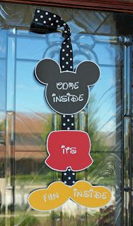 a mickey mouse sign hanging on the side of a glass door that says code inside