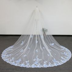 a white veil with blue flowers on it