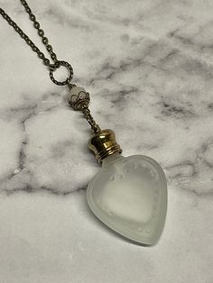 This vintage inspired necklace is made with a small frosted heart crystal perfume bottle.  The glass bottle is 4mm, The neck and gold cap is 1.5mm so the overall length is 5.5mm. It can hold 4ml of your favorite perfume.   You pick the chain length.  This necklace is very pretty would make a great gift!