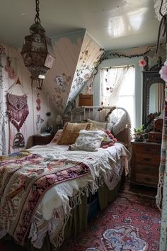 a bed sitting in a bedroom next to a window with lots of curtains on it