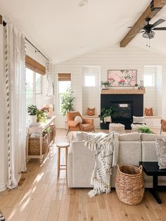 a living room filled with furniture and a fire place in the middle of a room