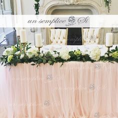 a table with flowers and candles on it in front of a mirror that says sparkle linens by