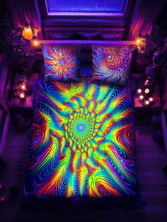 an image of a bed with colorful lights on it in the night time, as seen from above