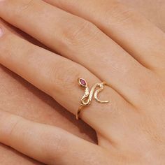 A beautiful yellow gold snake ring decorated with Ruby gemstone in an elegant winding design. Snakes are symbolic of renewal, making this ring perfect for those celebrating a new start. A quick buff with a jewellery cleaning cloth will remove metal tarnishes and keep gemstones looking glossy. Please avoid contact with perfumes, cosmetics or chemicals. Ruby Gold Jewellery, Gold Snake Ring, Snake Accessories, 55th Anniversary Gifts, Snake Jewellery, 15th Anniversary Gift, Snake Ring Gold, Snake Rings, Ring Diy