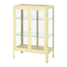 a white display cabinet with glass doors and shelves on the bottom, in front of a white background