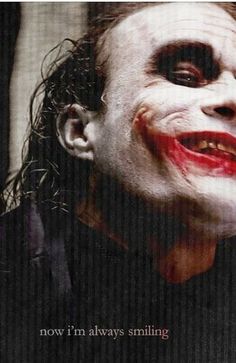the joker movie poster with his face painted white and red, as if he is smiling