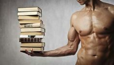 a shirtless man holding a stack of books