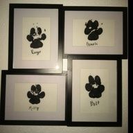 four black and white framed pictures with mickey mouse's faces drawn on the wall