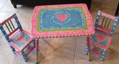 two children's chairs and table painted with words