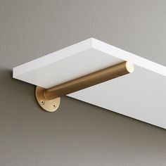 a close up of a light fixture on a wall with a white and gold finish