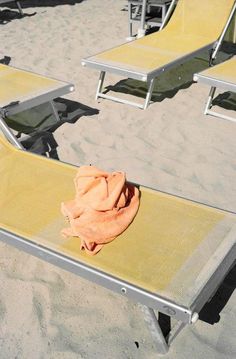 an orange towel sitting on top of a metal bench