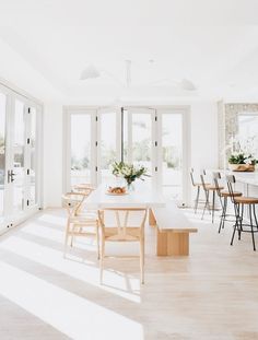 an open kitchen and dining room with white walls