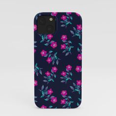 an iphone case with pink and blue flowers on it, against a dark background that is slightly overexposed